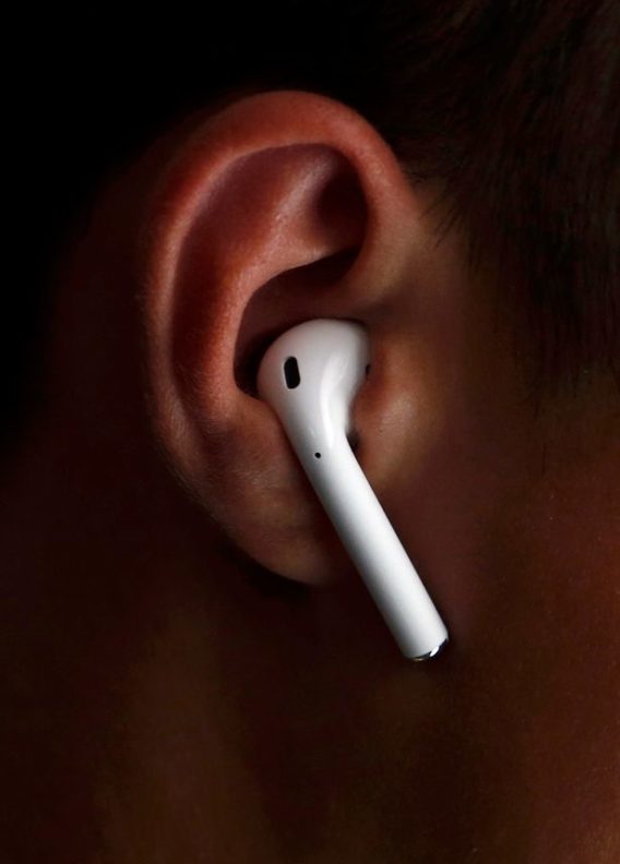 an-attendee-wears-the-apple-airpods-during-an-apple-media-event-in-san-francisco