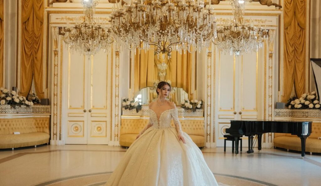 Bride wearing a ball gown wedding dress with a full skirt in an elegant ballroom