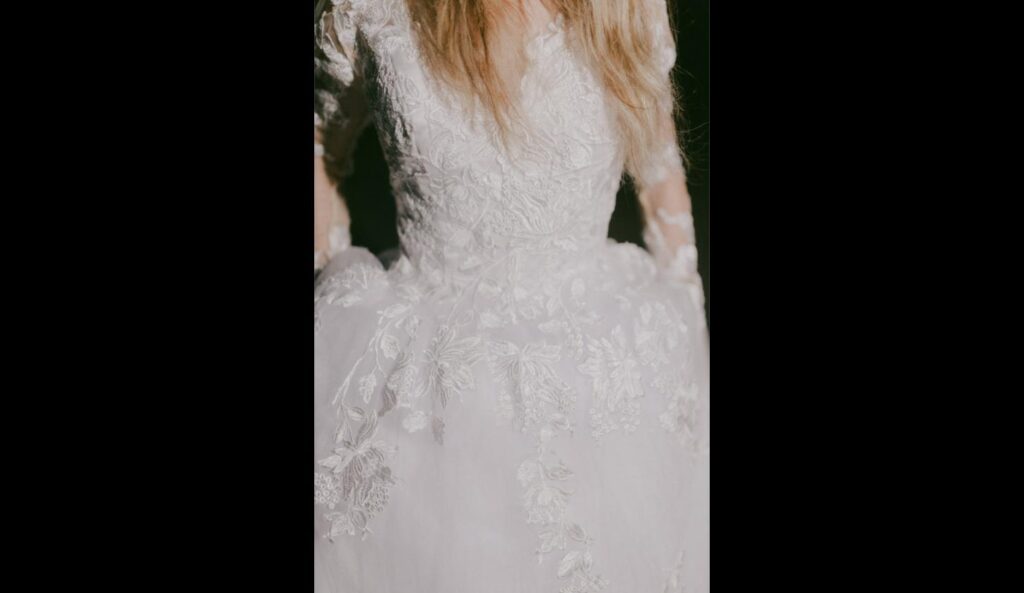 Close-up of delicate lace embroidery on a wedding dress bodice