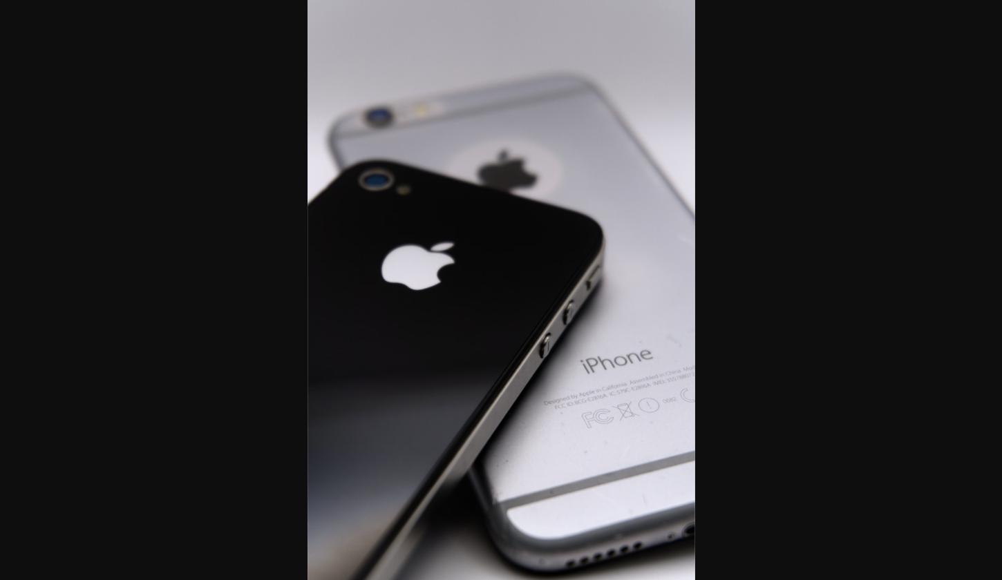 Close-up of two iPhones with visible Apple logos illustrating glossy finish design
