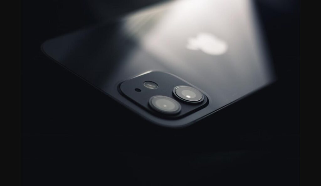 Macro close-up of an iPhone's rear camera lenses and glass back