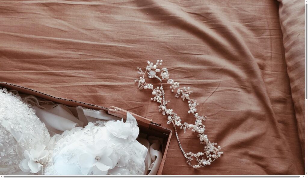 Wedding dress folded in an acid-free preservation box with a beaded hairpiece