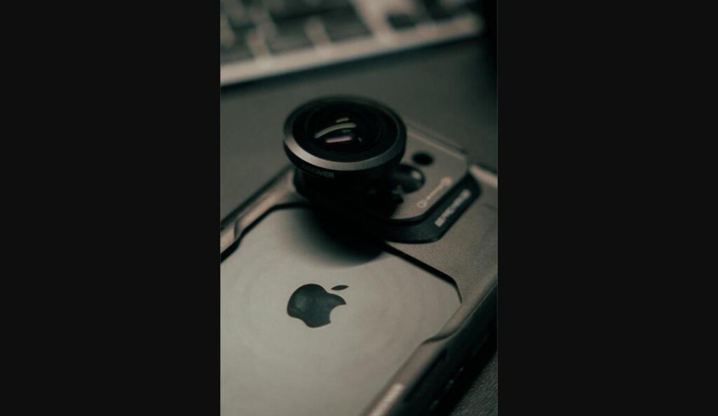 Close-up of an iPhone with an attachable camera lens accessory